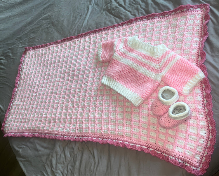 Tunisian crochet blanket with scalloped pink border, matching sweater and booties
