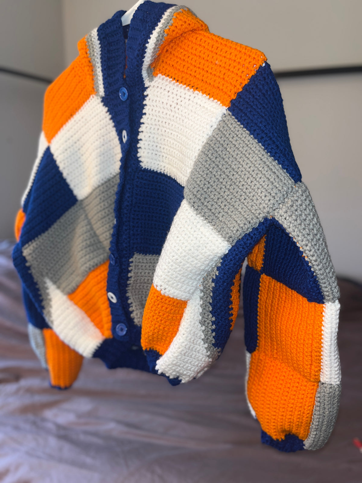 Orange and blue patchwork crochet cardigan, front angle